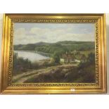 A gilt framed oil - cottages indistinctly signed,