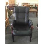 A stained beech and black leather reclining armchair