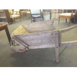 A mid 20th century wooden wheel barrow