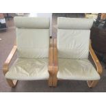 A pair of Ikea cream leather relaxer chairs