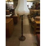 A reproduction standard lamp with shade