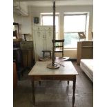 An antique pine kitchen table and a standard lamp