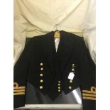 A naval two piece suit and a naval jacket and waist coat