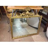 A decorative gilt framed over mantel mirror