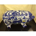 A large blue and white willow pattern china piggy bank