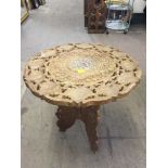 A carved inlaid tripod table