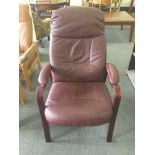 A stained beech and maroon leather reclining armchair