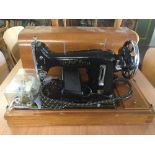 A mahogany cased Harris electric sewing machine and a mahogany coffee table