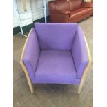 An oak framed purple upholstered armchair