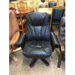 A black leather swivel armchair