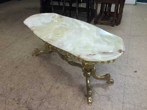 A shaped marble topped coffee table on gilt metal base