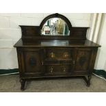 An early 20th century carved oak mirror back sideboard