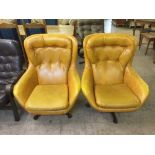 A pair of mid 20th century button back armchairs in vinyl covering
