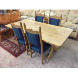 An oak refectory dining table on x frame support and four dining chairs