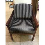 A mahogany framed armchair in striped covering