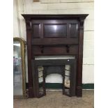 An early 20th century mahogany fire surround with cast iron insert