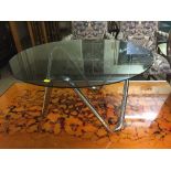 A 1970's circular smoked glass coffee table on chrome base