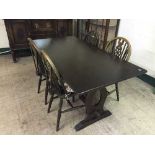 An oak refectory table and four wheel back chairs