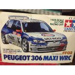 A boxed remote control Peugeot racing car with handset,