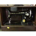 A cased hand sewing machine, brass plaque,