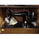 A cased Singer hand sewing machine