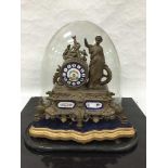 A late Victorian spelter and porcelain table clock, the 8 day movement striking on a bell,