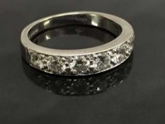 An 18ct white gold diamond half eternity ring, size M.