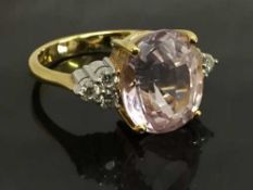 An 18ct gold pink tourmaline ring, set with diamond shoulders, size P.