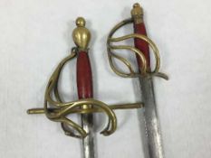 Two 17th century style swords with swept brass hilts,
