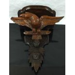 A late Victorian mahogany wall bracket, carved with an eagle beneath the table,