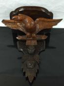 A late Victorian mahogany wall bracket, carved with an eagle beneath the table,