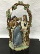 A Lladro bisque figure of a gentleman courting a lady beneath an arch, height 53cm.