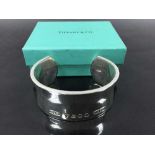 A Tiffany and Co. Sterling silver cuff bangle, with original retail pouch and box, 104.6g.