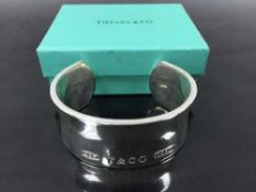 A Tiffany and Co. Sterling silver cuff bangle, with original retail pouch and box, 104.6g.