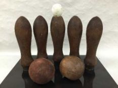 Nine late nineteenth/early twentieth century turned beech pub skittles, together with four balls.