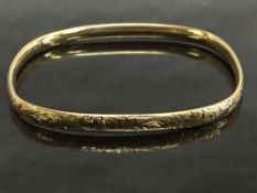 A 9ct gold shaped and engraved bangle, diameter 6.5 cm x 6 cm, 18.6g.