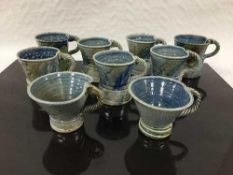 Jane Hamlyn (born 1940): Nine various salt glazed stoneware mug/cups, all of waisted form,