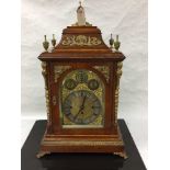 An impressive Victorian oak chiming double fusee bracket clock, the pediment with brass urn finials,