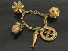 An 18ct gold fancy charm bracelet set with cabochon gemstones, 63.3g.