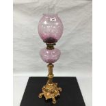 An ornate gilt metal and etched glass oil lamp, height 82cm.