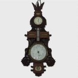 A carved oak combination wall clock/thermometer/barometer, circa 1900.