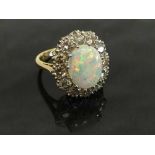 An 18ct gold opal and diamond cluster ring, size L.