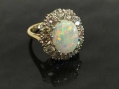 An 18ct gold opal and diamond cluster ring, size L.