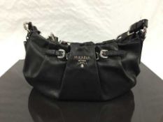 Prada : A lady's hand bag, soft black leather, with chrome labelling,