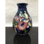 A Moorcroft orchid pattern bulbous vase, height 24cm.