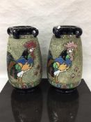 A pair of Czech amphora ware vases decorated with birds, 41cm.