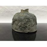 An eighteenth century Chinese bronze bell fragment, decorated with embossed dragons, width 14 cm.