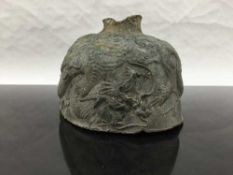 An eighteenth century Chinese bronze bell fragment, decorated with embossed dragons, width 14 cm.