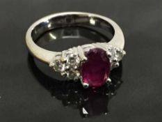 An 18ct white gold ruby ring, 1.82ct, set with six diamonds to the shoulders, 0.44ct, size O.