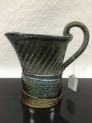 Jane Hamlyn (born 1940): A salt glazed stoneware jug, in blue/green glaze,